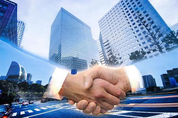 都市の風景と握手のイメージ